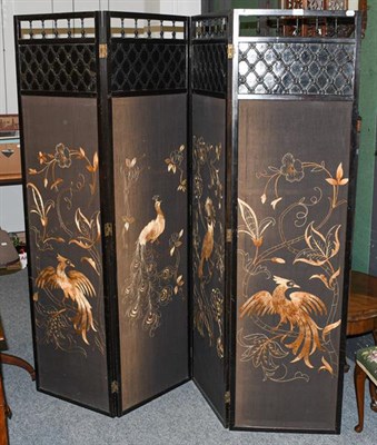 Lot 1264 - An Aesthetic movement ebonised four panel dressing screen, with gold embroidered panels...