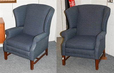 Lot 1271 - A pair of Georgian style wingback chairs with mahogany frames, upholstered in blue fabric, possibly
