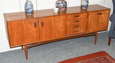 Lot 1272 - A mid 20th century Scandinavian style teak dining room suite comprising: a sideboard, 206cm by 46cm