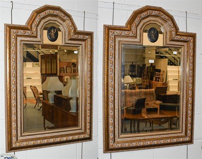 Lot 1273 - A pair of 20th century mirrors with bevelled glass plates with arched top, with gilt frames and...