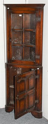 Lot 1274 - A reproduction oak freestanding corner cupboard, 66cm by 40cm by 181cm