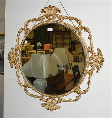 Lot 1275 - A 20th century parcel gilt openwork wall mirror with bevelled glass, 81cm wide