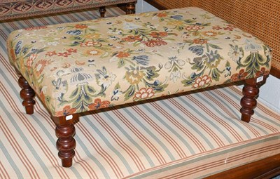 Lot 1287 - A reproduction footstool with needlepoint overstuffed seat, raised on turned supports, 94cm by 58cm
