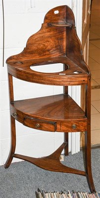 Lot 1288 - A George III mahogany bow front corner washstand, with single drawer, on square outswept...