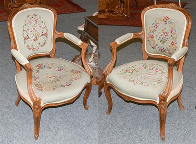 Lot 1304 - A pair of early 20th century carved walnut fauteuil, with needlepoint upholstery (2)