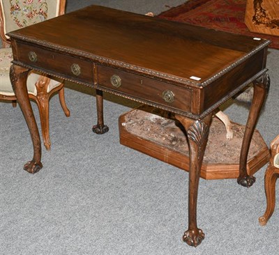 Lot 1305 - A Georgian style carved mahogany two drawer side table, with cabriole supports having shell...