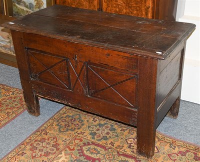 Lot 1307 - An 18th century French oak plank top coffer with carved panel front, 122cm by 60cm by 78cm
