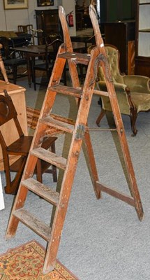 Lot 1308 - A pair of Victorian pine and cast iron ladders by Simplex