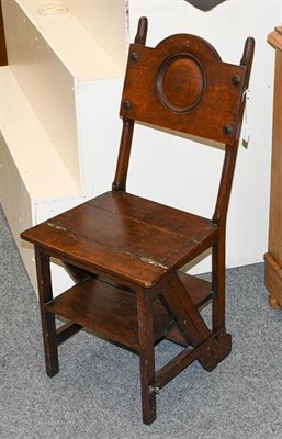Lot 1309 - An early 20th century oak metamorphic library chair