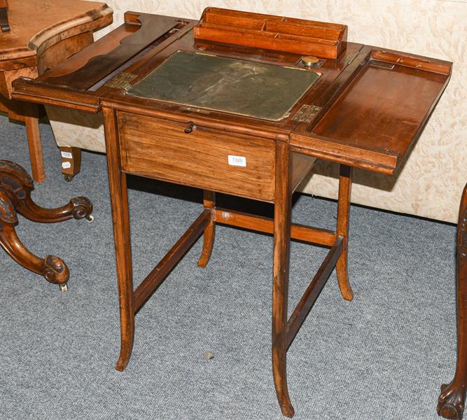 Lot 1320 - An Edwardian ladies mahogany small writing table, the folding top enclosing a fitted interior...