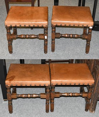 Lot 1327 - A set of four oak framed stools with tan leather and brass studded upholstery, with turned...