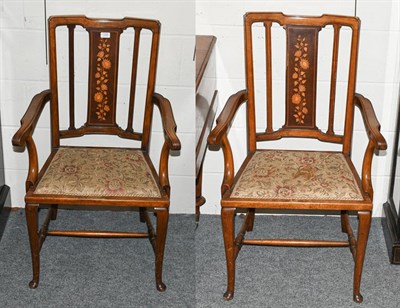 Lot 1335 - A pair of Edwardian marquetry inlaid mahogany armchairs, raised on plain cabriole supports with...