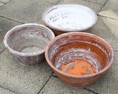 Lot 1345 - Three weathered terracotta dough bowls/planters, largest 57cm diameter