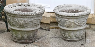 Lot 1353 - A large pair of composition garden planters of tapering form moulded with masks and stiff...