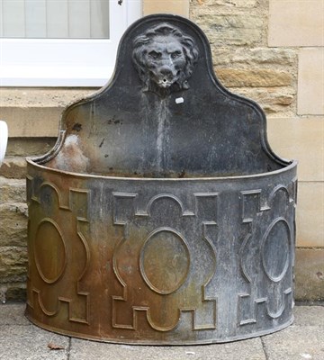 Lot 1355 - A Georgian style lead fountain of demi-lune form, ornamented with a lion mask and decorated...