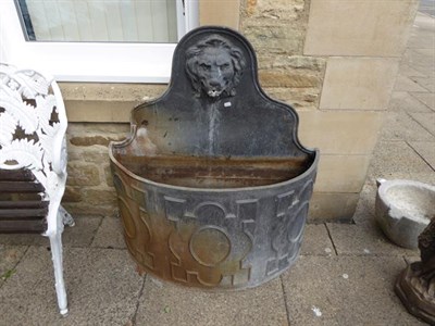Lot 1355 - A Georgian style lead fountain of demi-lune form, ornamented with a lion mask and decorated...