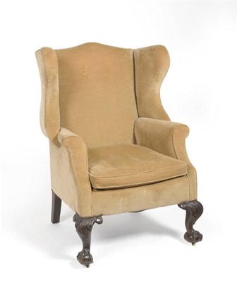 Lot 1701 - A Victorian Wing Back Armchair, late 19th century, upholstered in faded brown velvet, with...