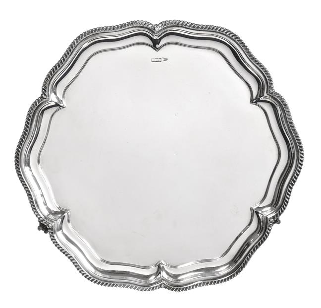 Lot 2096 - A George V Silver Salver, by Walker and Hall, Sheffield, 1915, shaped circular and on three...