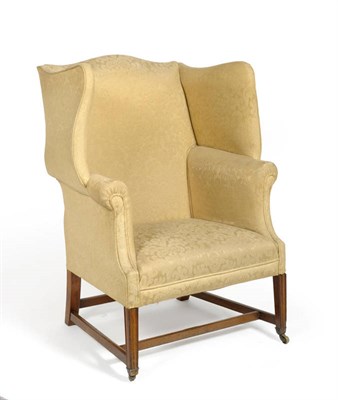 Lot 1709 - A George III Wing Back Armchair, late 18th century, upholstered in beige silk damask, with...