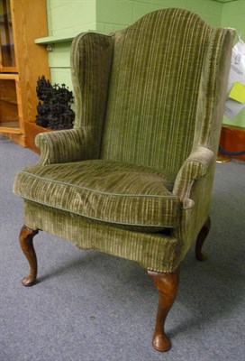 Lot 1710 - An Early Georgian Style Wing Back Chair, upholstered in modern green chenille, the rounded arm...