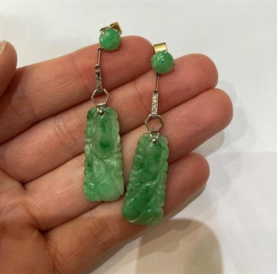 Lot 2178 - A Pair of Jade and Diamond Drop Earrings, a round cabochon jade suspends a white geometric...
