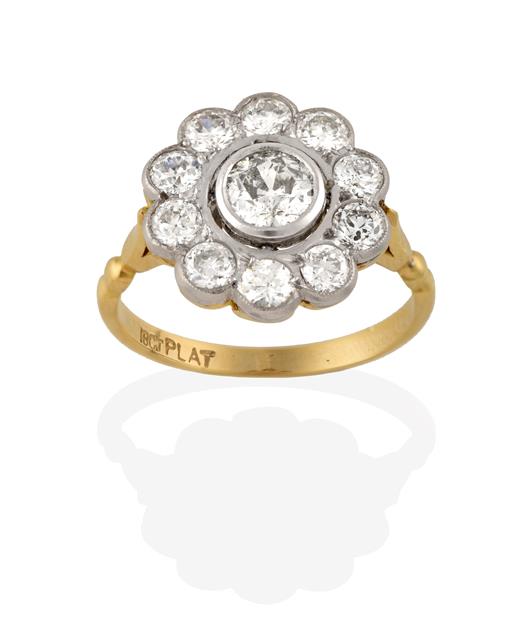 Lot 2189 - A Diamond Cluster Ring, an old cut diamond within a spaced border of smaller old cut diamonds,...