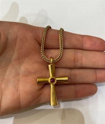 Lot 2197 - A Ruby Cross Pendant on Chain, by Ilias Lalaounis, the cross inset with a round cabochon ruby...