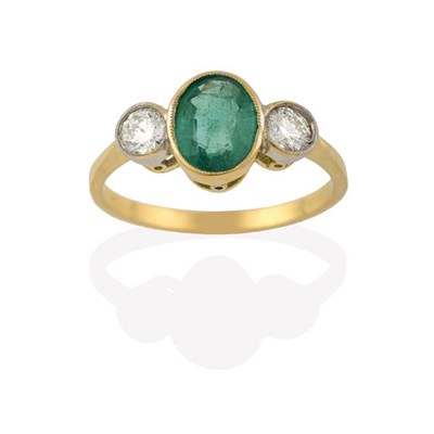 Lot 2199 - An Emerald and Diamond Three Stone Ring, the oval cut emerald in a yellow millegrain setting,...