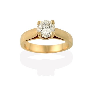 Lot 2201 - A Diamond Solitaire Ring, the round brilliant cut diamond in a yellow four claw setting, to a...