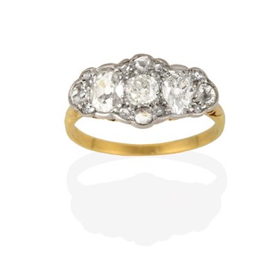 Lot 2202 - A Diamond Cluster Ring, an old cut diamond flanked by oval cut diamonds, within a border of old cut