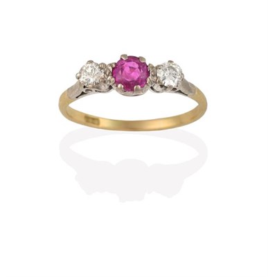 Lot 2209 - A Pink Sapphire and Diamond Three Stone Ring, the central round cut pink sapphire flanked by...