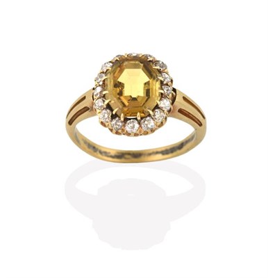 Lot 2216 - A Chrysoberyl and Diamond Cluster Ring, the octagonal shaped chrysoberyl within a border of old cut