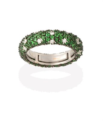 Lot 2229 - A Green Garnet and Diamond Eternity Ring, round brilliant cut diamonds and round cut green...