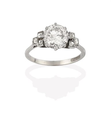 Lot 2234 - A Diamond Solitaire Ring, the round brilliant cut diamond to old cut diamond set stepped shoulders