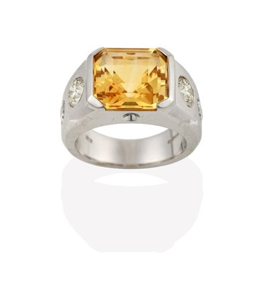 Lot 2240 - An 18 Carat White Gold Contemporary Citrine and Diamond Ring, the emerald-cut citrine in an...