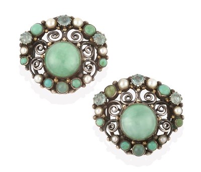 Lot 2244 - A Pair of Multi-Gem Set Clips, attributed to Dorrie Nossiter, a jadeite cabochon within a wire...