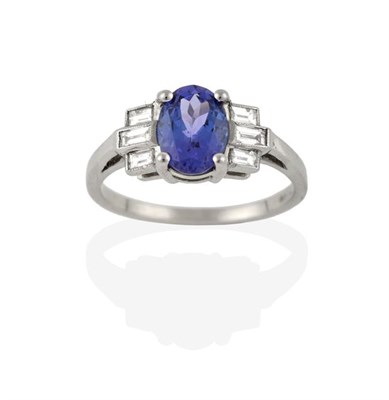 Lot 2255 - An Art Deco Style Tanzanite and Diamond Ring, the oval cut tanzanite in a white claw setting,...