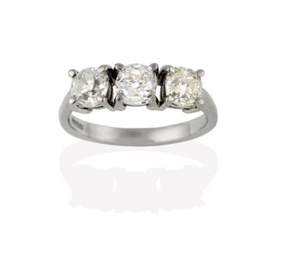 Lot 2256 - An 18 Carat White Gold Diamond Three Stone Ring, the old cut diamonds in claw settings, to a...
