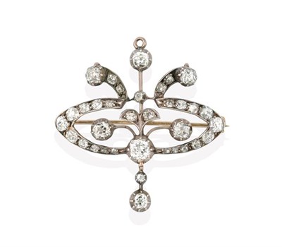 Lot 2260 - An Edwardian Diamond Brooch/Pendant, the openwork scroll cartouche set throughout with old cut...