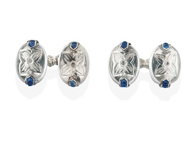 Lot 2267 - A Pair of Rock Crystal and Sapphire Cufflinks, by Cartier, the oval cabochon rock crystals...