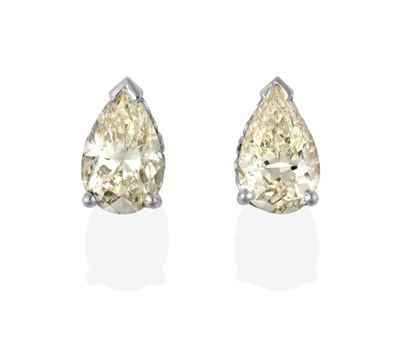 Lot 2268 - A Pair of Diamond Solitaire Earrings, the pear shaped diamonds in white claw settings, total...