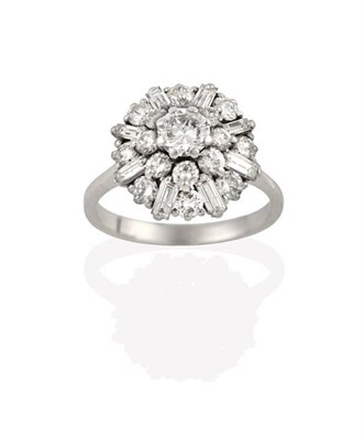 Lot 2269 - A Diamond Cluster Ring, the central raised round brilliant cut diamond within a border of...