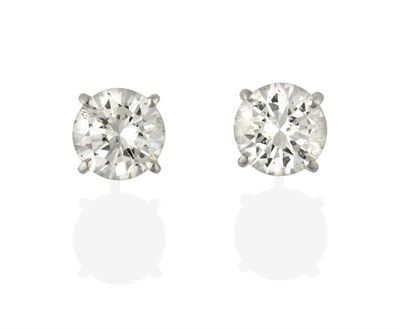 Lot 2270 - A Pair of Diamond Solitaire Earrings, the round brilliant cut diamonds in white four claw settings