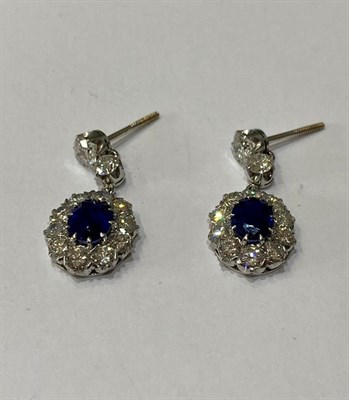 Lot 2281 - A Pair of Sapphire and Diamond Drop Earrings, two graduated round brilliant cut diamonds...