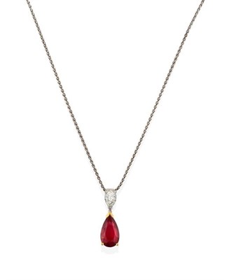 Lot 2282 - A Ruby and Diamond Pendant on Chain, a pear shaped ruby in a yellow claw setting, surmounted by...