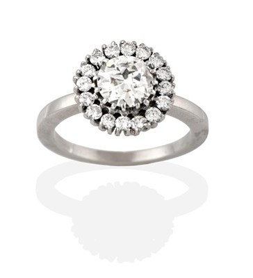 Lot 2286 - A Diamond Cluster Ring, the round brilliant cut diamond within a border of smaller round...
