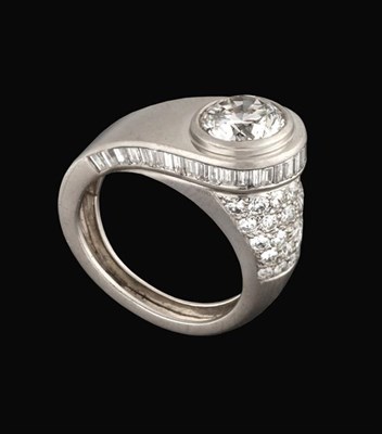 Lot 2291 - An Architectural Style Diamond Solitaire Ring, circa 1935, the raised round brilliant cut...
