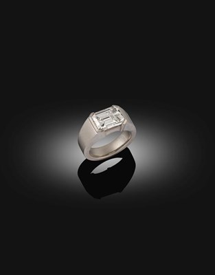 Lot 2295 - A Contemporary Diamond Solitaire Ring, the emerald-cut diamond in an extended claw setting, to...