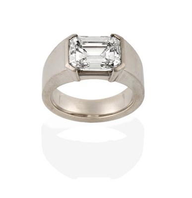Lot 2295 - A Contemporary Diamond Solitaire Ring, the emerald-cut diamond in an extended claw setting, to...