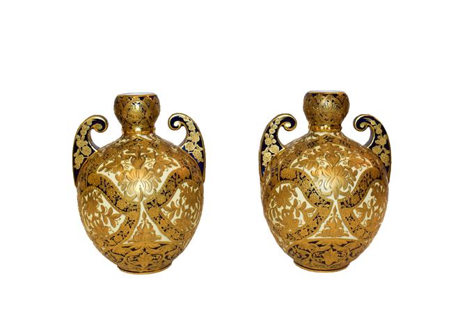 Lot 9 - Royal Crown Derby: A pair of gilt twin-handled vases, 18cm high